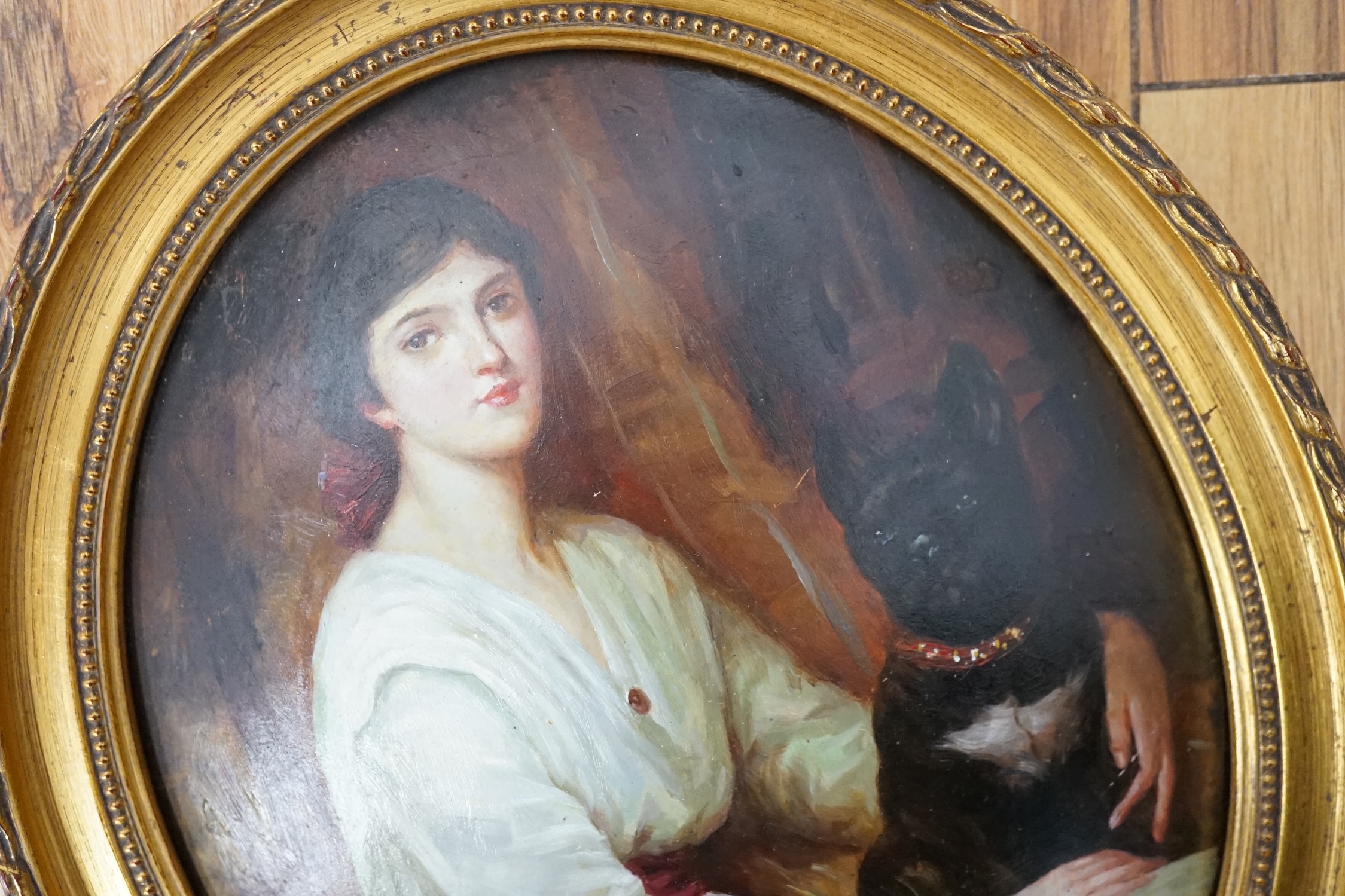 F. Jacob, oval oil on moulded composition, Study of a young lady with a dog, signed, 24 x 19cm, gilt frame. Condition - fair to good